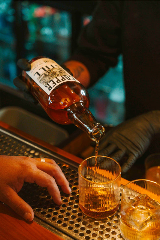 Bartender pouring Copper Still